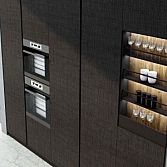 Premiumline kitchen with black handleless profile in walnut woodgrain and dark Graphite matt finish